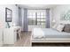 Serene bedroom with a queen bed, built-in desk, and access to a private balcony at 7702 Lake Vista Ct # 306, Lakewood Ranch, FL 34202