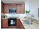 Well-equipped kitchen with granite countertops at 7702 Lake Vista Ct # 306, Lakewood Ranch, FL 34202