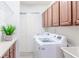 Bright laundry room with washer, dryer, and cabinets at 7702 Lake Vista Ct # 306, Lakewood Ranch, FL 34202