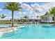 Community pool with striped shade cabanas, lounge chairs, and steps at 8035 Redonda Loop, Bradenton, FL 34202