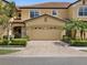 Tan two-story townhome with a two-car garage at 8141 Miramar Way # 8141, Lakewood Ranch, FL 34202