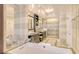 Modern bathroom featuring dual vanities, a soaking tub, and glass shower at 915 Seaside Dr # 613 Weeks 4-5, Sarasota, FL 34242