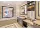 Elegant Primary bathroom with soaking tub, vanity area, and view of bedroom at 915 Seaside Dr # 613 Weeks 4-5, Sarasota, FL 34242