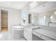 Bright bathroom features a soaking tub, marble accents, and vanity at 9153 Radiant Cir, Sarasota, FL 34241
