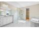 An elegant bathroom with a glass shower, marble accents and double sinks at 9153 Radiant Cir, Sarasota, FL 34241