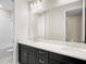Bathroom with double sink, black cabinets, and large mirror at 9153 Radiant Cir, Sarasota, FL 34241