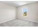 Bedroom featuring grey carpet and a window with outdoor views at 9153 Radiant Cir, Sarasota, FL 34241