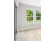 A bedroom with a view of the outdoors, featuring bright natural light and a neutral color palette at 9153 Radiant Cir, Sarasota, FL 34241