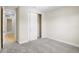 Bedroom featuring grey carpet, a closet with sliding doors and and open doorway to another room at 9153 Radiant Cir, Sarasota, FL 34241
