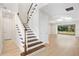 Lovely staircase and entryway featuring wood floors and natural light at 9153 Radiant Cir, Sarasota, FL 34241