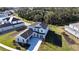 New construction home featuring light blue exterior paint, a gray roof and green landscaping at 9153 Radiant Cir, Sarasota, FL 34241