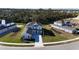 Two-story home with a light blue exterior, a dark gray roof, and newly planted green grass and landscaping at 9153 Radiant Cir, Sarasota, FL 34241