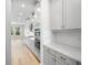 Modern kitchen featuring white cabinets, stainless steel appliances, and light hardwood flooring at 9153 Radiant Cir, Sarasota, FL 34241