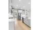 Contemporary kitchen with white cabinets, stainless appliances, and quartz countertops offer ample space at 9153 Radiant Cir, Sarasota, FL 34241