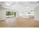Expansive living room features a coffered ceiling, seamless access to the outdoor lanai, and an open floorplan at 9153 Radiant Cir, Sarasota, FL 34241