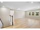 Bright living room featuring hardwood floors, recessed lighting, and three windows offering natural light at 9153 Radiant Cir, Sarasota, FL 34241