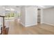 Open-concept living area with wood floors, white walls, recessed lighting, and a view of the backyard at 9153 Radiant Cir, Sarasota, FL 34241