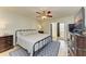 Main bedroom with king-size bed, dark wood furniture, and access to patio at 141 Wild Palm Dr, Bradenton, FL 34210