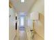 Bright hallway with light wood floors and a stylish lamp at 141 Wild Palm Dr, Bradenton, FL 34210