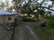 Landscaped backyard with a pathway and tropical plants at 1416 26Th W St, Bradenton, FL 34205