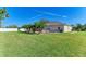Large backyard with grassy lawn and patio area at 1605 21St W Ave, Palmetto, FL 34221