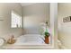 Relaxing bathroom with a corner soaking tub and window at 1605 21St W Ave, Palmetto, FL 34221