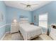 Bedroom with a full-size bed, ceiling fan, and light color scheme at 1605 21St W Ave, Palmetto, FL 34221
