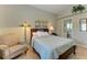 Bedroom with a queen bed, armchair, and ensuite bathroom access at 1605 21St W Ave, Palmetto, FL 34221