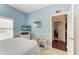 Bedroom with a full-size bed and access to a hallway at 1605 21St W Ave, Palmetto, FL 34221