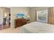 Bedroom with dresser, TV, and view into adjacent living area at 1605 21St W Ave, Palmetto, FL 34221