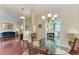 Spacious dining area adjacent to the living room, featuring hardwood floors and a glass-top table at 1605 21St W Ave, Palmetto, FL 34221