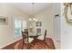 Open dining room with a glass table, wicker chairs, and hardwood floors at 1605 21St W Ave, Palmetto, FL 34221