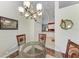 Bright dining room featuring a glass table and four chairs, with a view into the kitchen at 1605 21St W Ave, Palmetto, FL 34221