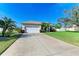 Landscaped yard with a two-car garage and spacious driveway at 1605 21St W Ave, Palmetto, FL 34221