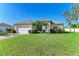 One-story home with a large yard, driveway, and attached garage at 1605 21St W Ave, Palmetto, FL 34221