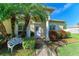 Inviting front entrance with a white door, ornate bench, and lush landscaping at 1605 21St W Ave, Palmetto, FL 34221