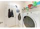 Bright laundry room with washer, dryer, and storage shelves at 1605 21St W Ave, Palmetto, FL 34221