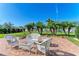 Brick patio with white wicker furniture and lush landscaping at 1605 21St W Ave, Palmetto, FL 34221