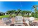 Brick patio with white wicker furniture and lush landscaping at 1605 21St W Ave, Palmetto, FL 34221