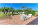 Brick patio with white wicker furniture and lush landscaping at 1605 21St W Ave, Palmetto, FL 34221