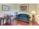 Cozy sitting area featuring hardwood floors, a comfortable couch, and decorative accents at 1605 21St W Ave, Palmetto, FL 34221