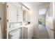 Clean bathroom with vanity, toilet and access to bedroom at 207 Rubens Dr # D, Nokomis, FL 34275