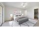 This bedroom boasts a large window, ceiling fan, and a walk-in closet for ample storage at 207 Rubens Dr # D, Nokomis, FL 34275