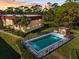 Community pool with fenced surround plus an adjacent cabana and seating against a backdrop of mature trees at 207 Rubens Dr # D, Nokomis, FL 34275