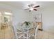 Cozy dining area with a glass table, seating for four, and a decorative cabinet at 207 Rubens Dr # D, Nokomis, FL 34275