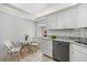 Bright kitchen featuring white cabinets and granite at 207 Rubens Dr # D, Nokomis, FL 34275