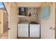 Convenient laundry closet featuring a washer, dryer, water heater and shelf for storage at 207 Rubens Dr # D, Nokomis, FL 34275