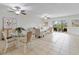 Open living and dining area with tile flooring, ceiling fans, and plenty of natural light at 207 Rubens Dr # D, Nokomis, FL 34275