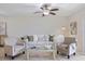 Cozy living room with neutral furniture, tile floors, and a decorative floor lamp at 207 Rubens Dr # D, Nokomis, FL 34275