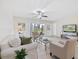 Bright living room featuring tile floors, neutral decor, and access to a screened patio at 207 Rubens Dr # D, Nokomis, FL 34275